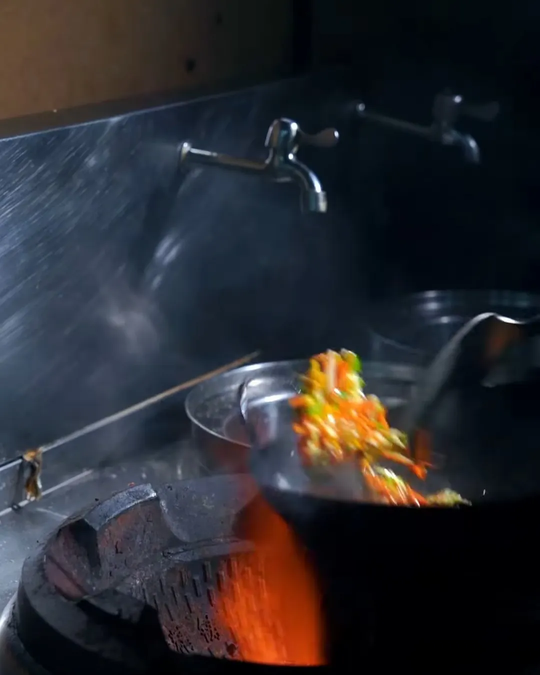 Wok over open flame